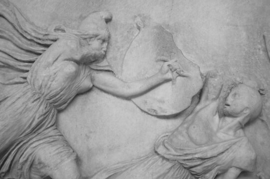 Marble statue of Amazon and Greek fight. Amazon is defeating Greek warrior - hero. . Greece in antique 