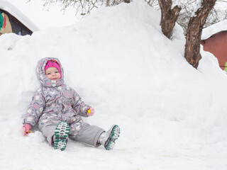 beautiful two year old child is tired and resting in the snow copy space