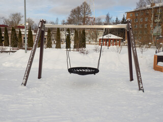 empty swing at the playground in winter