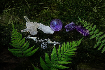quartz minerals, witch amulet with pentagram on moss close up, forest dark natural background....