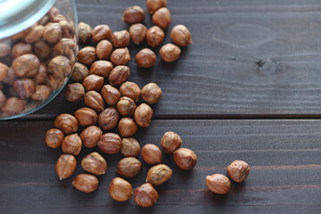 Close up brown hazel nut on wooden desk. Healthy organic snack hazelnut. Vegetarian nutrition.