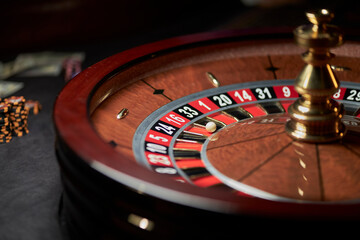 casino roulette wheel, casino gambling concept. Roulette table in a casino, with many games and slots, roulette wheel in the foreground. Casino roulette close-up. gambling for money.