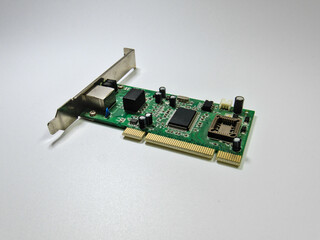 Ethernet network adapter computer card standing on a white background, bottom side close up view