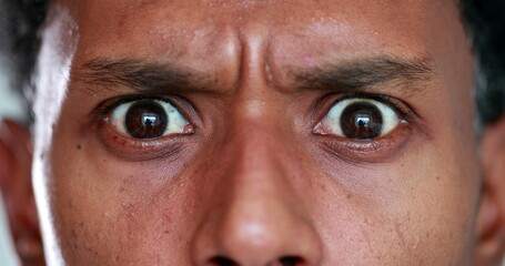 Person receiving shocking upsetting news, emotional reaction macro close-up of eyes showing terror...