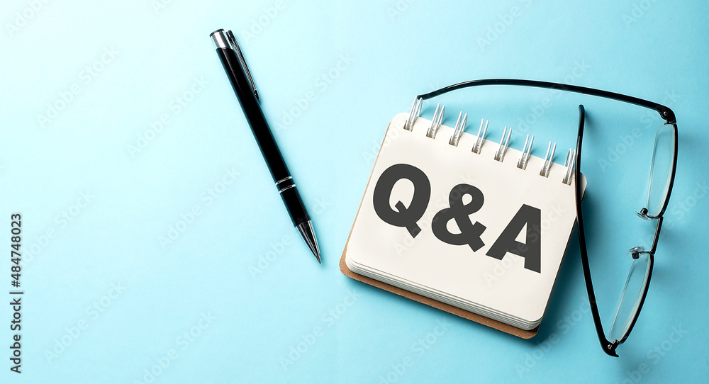 Poster q and a text written on a notepad on the blue background