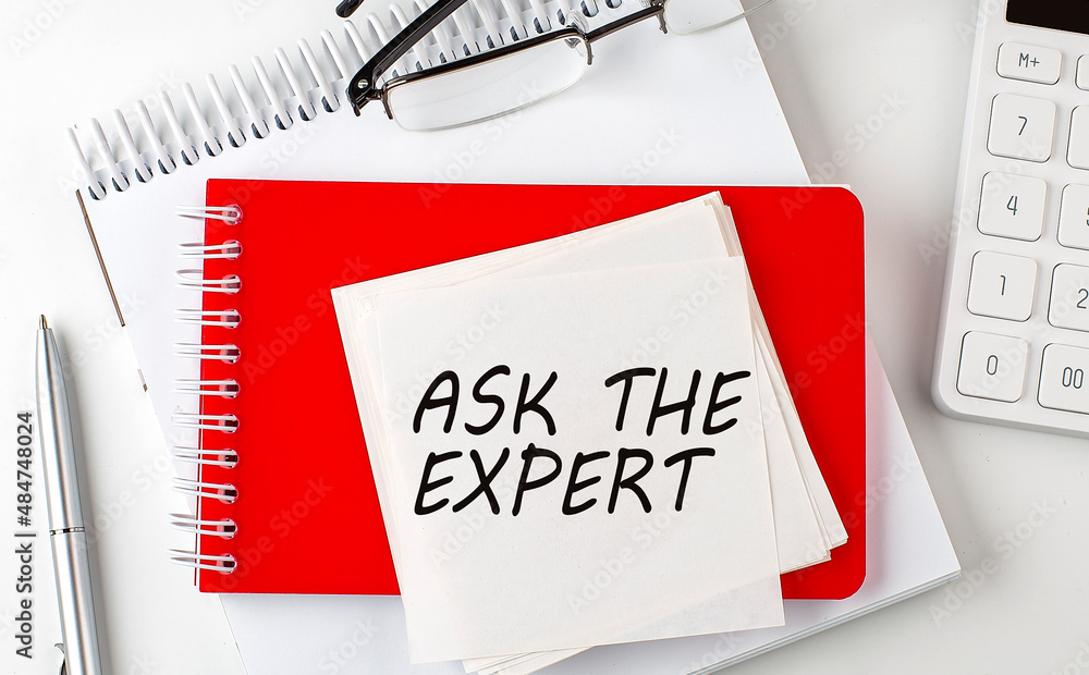 Poster ask the expert word on sticker on notepad with pen and calculator