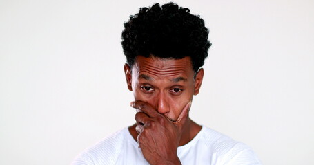 Pensive person thinking about decision. Thoughtful contemplative black man pondering tough decision