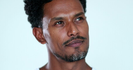 Pensive African man close-up face portrait. Thoughtful black person thinking about solution