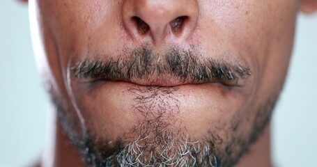 Obraz premium Man with mouth zipped, lips pressed close-up, feeling anxiety