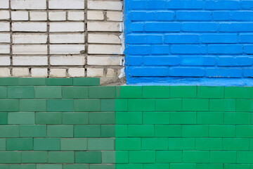 Brick wall painted in different colors by different owners