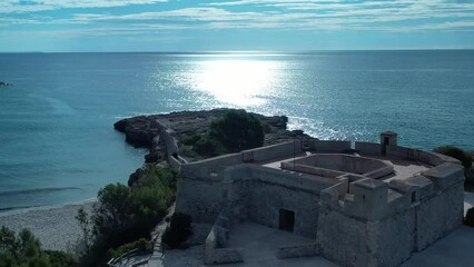 Playa y Castillo de Sant Jordi d'Alfama en l'Ametlla de Mar Tarragona Spain