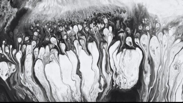 Fluid art detailed video featuring paint mixing, waves and whirlpools. Creating an abstract backdrop with liquid overflowing paints without saturation. Black and white texture of fluent inks mixture.