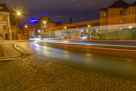 Night city landscape, tram passing through the street