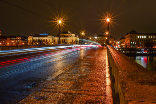 Night city landscape, fast traffic on the bridge