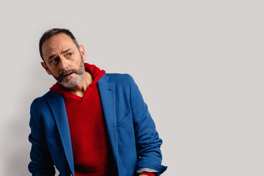 Portrait Of Sexy Mature Grey Bearded Man. Stylish Bearded Senior Bearded Man Looking Away From Camera Isolated On Grey Background.