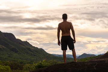 View to man seen from behind enjoying beautiful wild landscape