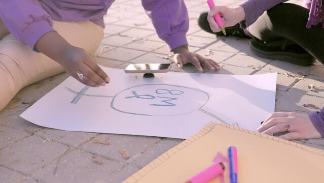 2 multicultural woman prepare banners for 8 march feminism protest. cuban and hispanic slow motion 