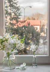 A bouquet of white lilies on a windowsill.