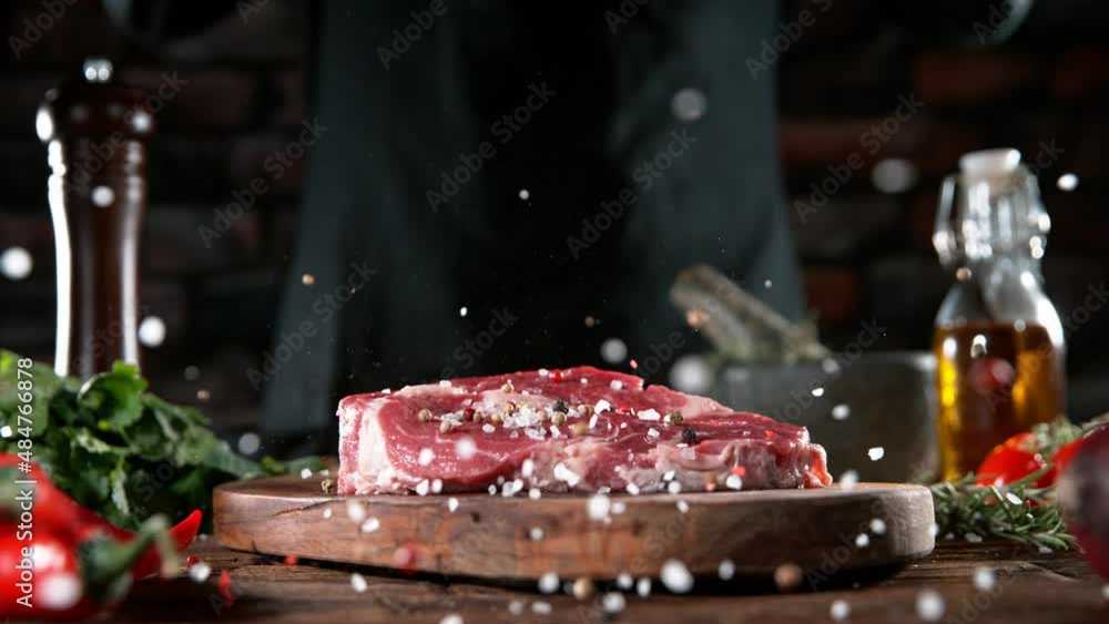 Sticker super slow motion of chef throwing spices on beef steak. filmed on high speed cinema camera, 1000 fp