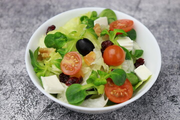 Healthy fresh salad of fresh sprouts, cherry, lettuce, mango, cheese, healthy food concept.