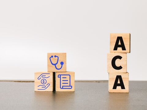 Wooden cubes with alphabets ACA and medical icons.
