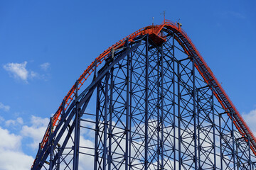 A large red steel rollercoaster in Blackpool Beach, England