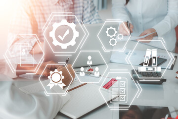 Quality management with QA (assurance), QC (control) and improvement, Business team discussing data with document data with VR screen quality management icon on desk table.