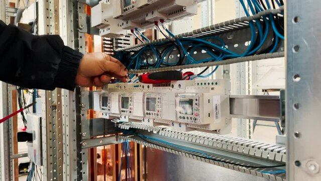 Wiring harness while tightening electrical terminals with screwdriver