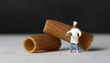 Close-up images of pasta noodles and miniature people. The miniature people and pasta noodles with Business concept.
