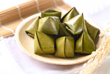 Thai dessert (Khanom Tian), Sweet dough pyramid stuffed with coconut wrapped by banana leaf