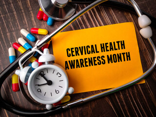 Top view clock,stethoscope,pill capsule and colored notepaper with text CERVICAL HEALTH AWARENESS...
