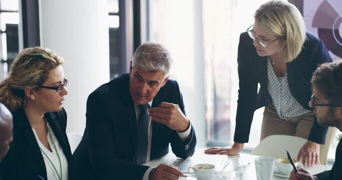 Managing an empire with regular meetings. Diverse group of business people sitting in office and having a boardroom meeting. Group of business colleagues sitting and discussing, strategy, plan