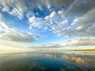 Dramatic puffy white clouds over a lake and wetlands in Florida at sunset