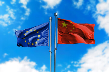 Flags of European Union and China on the wind against blue sky