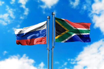 Flags of Russia and South Africa on the wind against blue sky