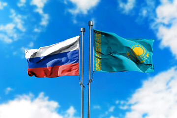 Flags of Russia and Kazakhstan on the wind against blue sky