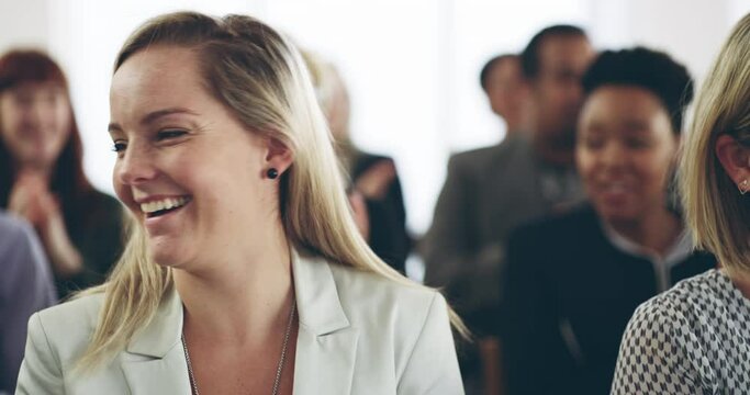 Those presentations that inspire laughter. Young business women laughing and clapping while sitting at a conference. Smiling businesspeople applauding during a corporate training seminar meeting