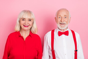 Portrait of attractive cheery gray-haired couple festal occasion time isolated over pink pastel color background