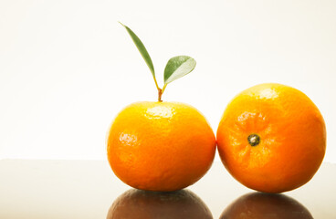 Group of oranges and leaves. Fresh-looking yellow fruit isolated on a white background. Fruits with vitamins and good health focus on specific points. Advertising concept and healthy, space for text