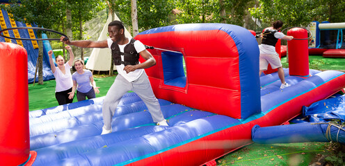 Competition of two men - who quickly throw a hoop on a stick. High quality photo