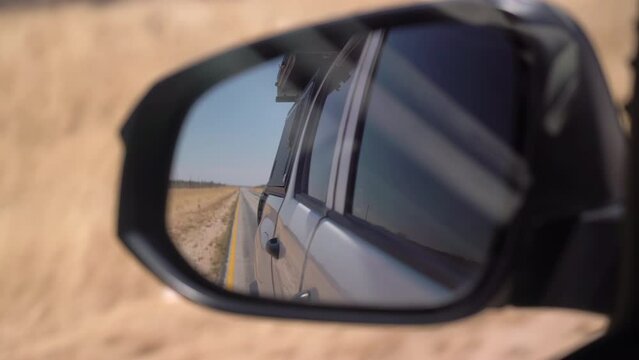 POV car driving on asphalt highway. Left side traffic. Savannah road in Africa.