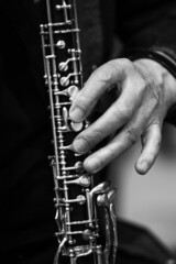 The hand of a musician playing the clarinet in black and white - 484796485