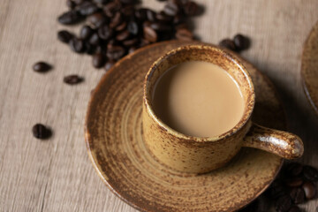 Fototapeta na wymiar hot coffee in brown cup on wooden background