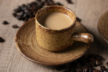 hot coffee in brown cup on wooden background