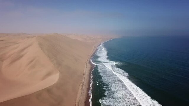 Sandwich Harbour in Namibia at the coast of the Atlantic Ocean. Sandy beach.