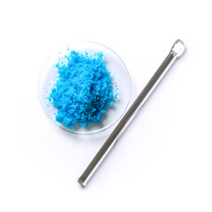 Copper(II) sulfate in Chemical Watch Glass placed next to the stirring rod on laboratory table.