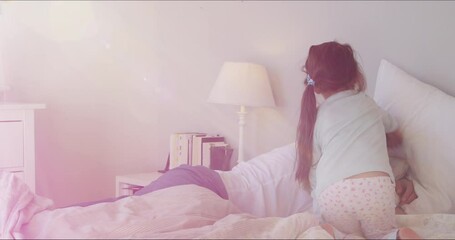 Wake up Daddy. Young family, with cute daughter and dad in bed at home Little girl child waking up father during the morning in the bedroom