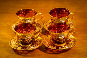 Four gold and red teacups for teatime