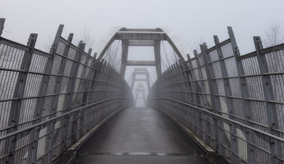 Pedestrian bridge over the Trans-Canada Highway 1 during a winter foggy morning. Surrey, Greater Vancouver, British Columbia, Canada.