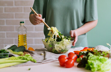 person preparing salad. Kitchen ingredients. Healthy lifestyle. Vegan food. Summer time. Spring vitamins. 